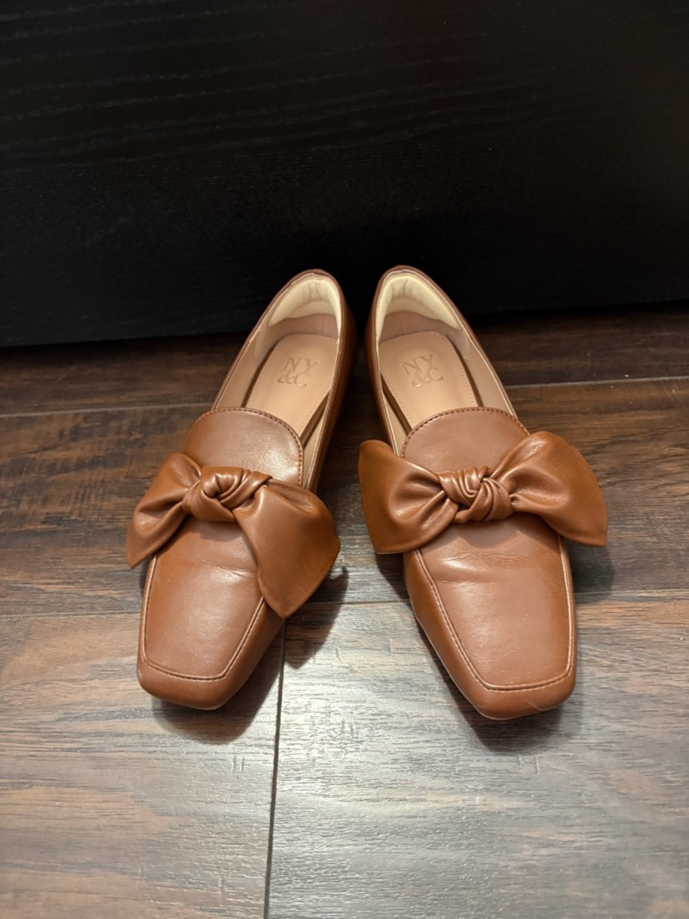Brown loafers with stylish bow